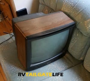The old TV looks so sad on the couch. Oh well, you are outta here!