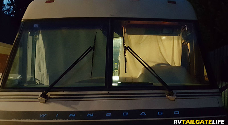 RV from the outside at night with interior lights on to see difference in blackout drapes versus old drapes