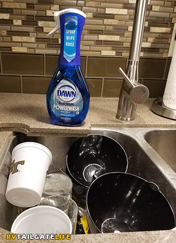 The kitchen sink drains into the RV gray tank and can leave food bits stuck in there... creating nasty odors that come out through your RV shower.