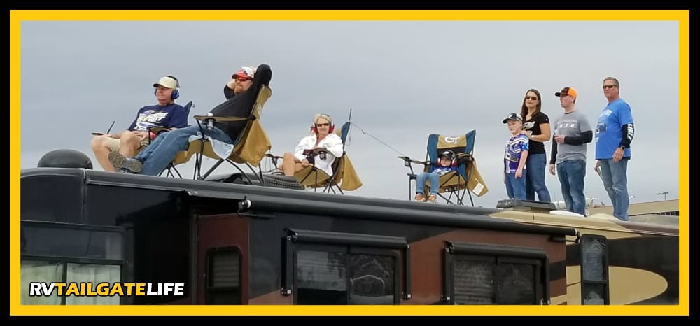 The best view of the NASCAR race is on the top of the RV in the infield.