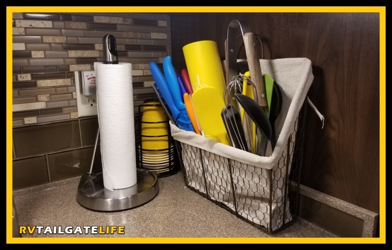 Keep the RV kitchen counter clear with just a few items, like a Solo Cup holder and paper towels. 
