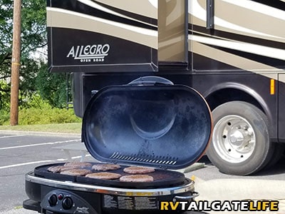 Quientessential RV tailgating scene - the grill with hamburgers a grilling