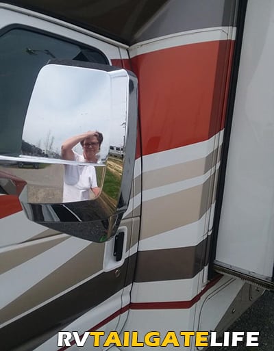 RV Renter looking frustrated in the mirror of the Rental RV 