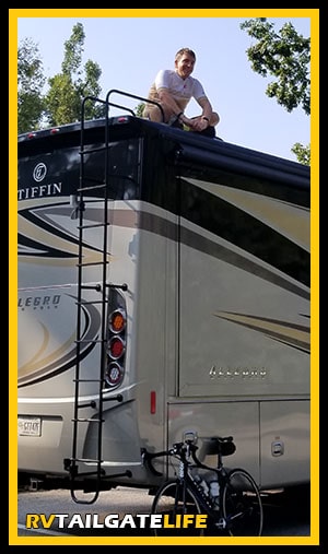 Dan on top of the RV with his bicycle at the bottom